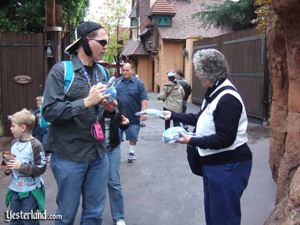 A Dream Squad cast member dispenses “dream” ears to park guests